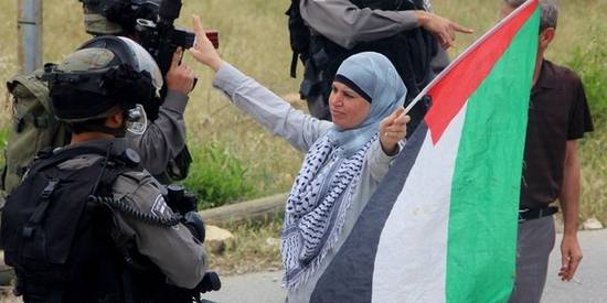 Manal Taimimi, delante de soldados israelíes durante la celebración de una protesta el 3 de mayo de 2013. © Tamimi Press